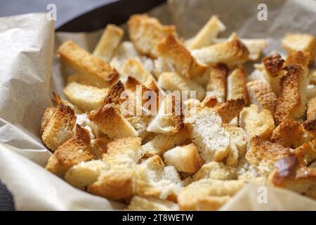 Crackers, baked dry pieces of white bread, in bulk, selective focus. Stock Photo