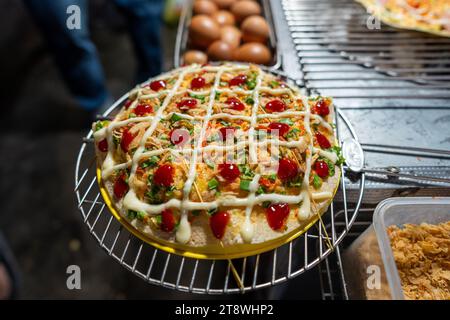Close up of Banh Trang Nuong Or local vietnam pizza is a popular street food for tourist and people in Da Lat, Vietnam. Food and travel concept Stock Photo