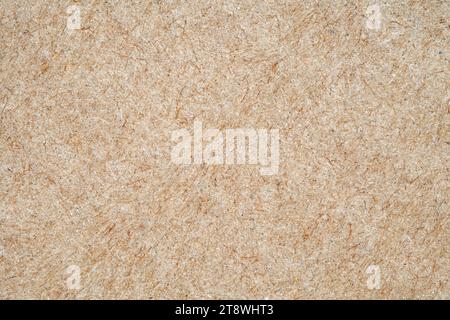 Cardboard surface close-up, craft beige paper structure, macro, rough background of recycled waste paper Stock Photo