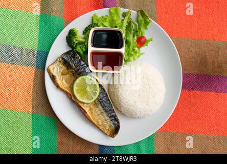 Grilled Saba or Mackerel menu with sweet sauce, vegetable and rice on white plate at the table Stock Photo