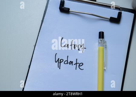 Concept of Latest Update write on sticky notes isolated on Wooden Table. Stock Photo