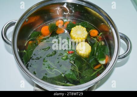 Sayur bening bayam, Spinach Clear Vegetable. Indonesian food of spinach, spinach soup with corn Stock Photo