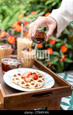 Cold milk coffee cups in Da Lat city, Vietnam style on table. Selective Focus. Drink and travel concept Stock Photo