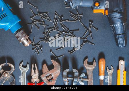 Sets of hand and power tools for repair lie on the work table Stock Photo