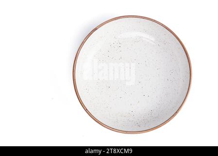 beige round ceramic plate with dotted isolated on a white background. top view. High quality photo Stock Photo