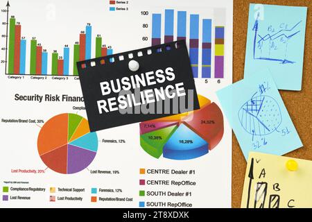 Business concept. There are business charts, sticky notes and black paper with the inscription on the board - business resilience Stock Photo