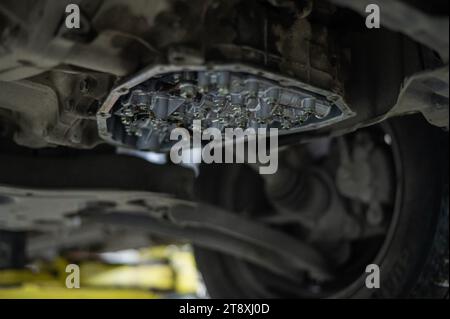 Close-up of a car's CVT gearbox on a lift.  Stock Photo