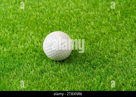 Sports, hockey ball on astro turf closeup with space for marketing or advertising outdoor. Stock Photo