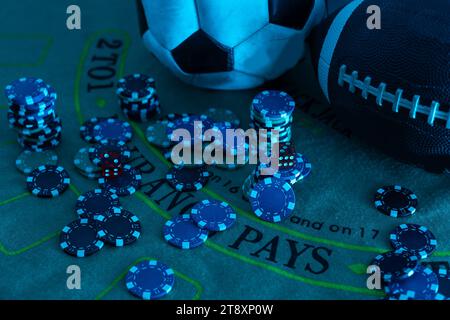 Image of several red dice falling on green table on background of multicolored spots Stock Photo