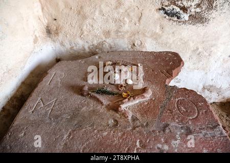 Grave stone with offerings in the interior of the porch, in the remains of St Andrews Kirk, North Berwick, East Lothian, Scotland, UK Stock Photo