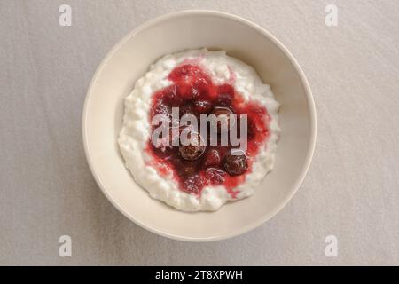 Risalamande, the Danish dessert is a rice pudding with vanilla, almonds and whipped cream, and it's typically served together with warm cherry sauce. Stock Photo