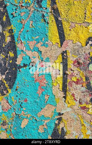Bright yellow and blue graffiti on chipping, textured concrete wall in abstract background asset art Stock Photo