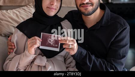 Husband And His Wife Holding Sonography Photo For There Fetus While ...