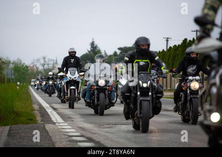group of motorcycle riders riding together on the public road Stock Photo