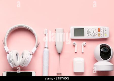Modern gadgets on pink background Stock Photo