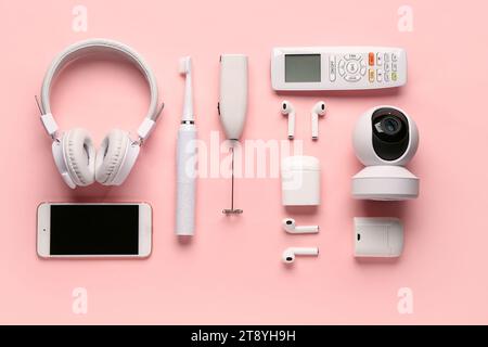 Modern gadgets on pink background Stock Photo