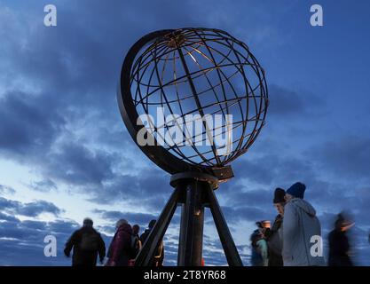 Nordkap, Norway. 24th Aug, 2023. In the early morning, tourists visit the globe on the North Cape's slate plateau, which is located around 300 meters above the Arctic Ocean. The steel sculpture is a landmark of the North Cape and was erected in 1978. Credit: Soeren Stache/dpa/Alamy Live News Stock Photo