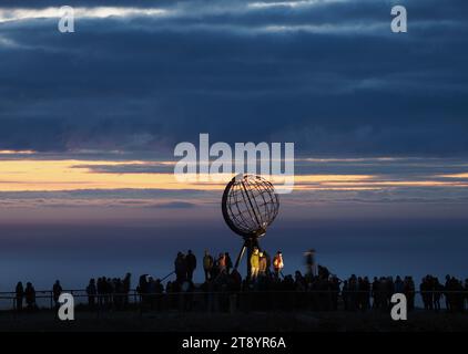 Nordkap, Norway. 24th Aug, 2023. In the early morning, tourists visit the globe on the North Cape's slate plateau, which is located around 300 meters above the Arctic Ocean. The steel sculpture is a landmark of the North Cape and was erected in 1978. Credit: Soeren Stache/dpa/Alamy Live News Stock Photo