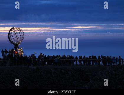 Nordkapp, Norway. 24th Aug, 2023. In the early morning, tourists visit the globe on the North Cape's slate plateau, which is located around 300 meters above the Arctic Ocean. The steel sculpture is a landmark of the North Cape and was erected in 1978. Credit: Soeren Stache/dpa/Alamy Live News Stock Photo