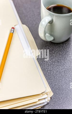 Close-up file folders and coffee on desk in an office Stock Photo