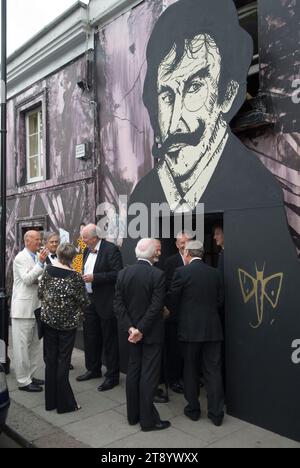 Chelsea Arts Club, London UK. The Whistler Dinner members and friends entering the club under a portrait of James Abbott McNeill Whistler. One of the founders of the Chelsea Arts Club. Chelsea, London, England 11th July 2011. 2010s England HOMER SYKES Stock Photo