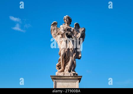 Rome, Italy - November 4 2023: One of Bernini Angels on the Ponte Sant Angelo Bridge with blue sky Stock Photo