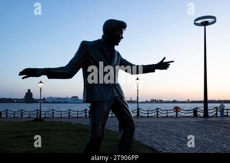 Liverpool, united kingdom May, 16, 2023 The silhouette of a statue dedicated to legendary British singer Billy Fury located on the Albert Dock in Live Stock Photo