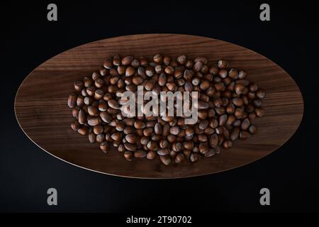 Fresh hazelnuts in a large dish top view dark ambience Stock Photo