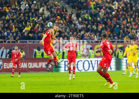 Bucharest, Romania. 22nd Nov, 2023.George Puscas of Romania and Nico Elvedi of Switzerland fighting for the ball during the UEFA Euro 2024, European Qualifiers, Group I football match between Romania and Switzerland on November 21, 2023 at Arena Nationala in Bucharest, Romania - Photo Mihnea Tatu/DPPI Credit: DPPI Media/Alamy Live News Stock Photo