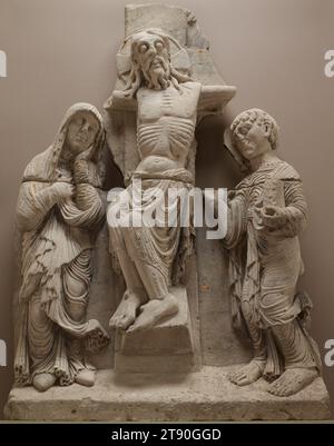 Crucifixion, c. 1180, 60 5/8 x 38 9/16 x 7 7/8 in. (154 x 98 x 20 cm.), Limestone, Spain, 12th century, Jesus is seen dead on the cross while his mother, Mary, and his favorite disciple, the Evangelist Saint John, mourn below. This large-scale work embodies the characteristics of Romanesque sculpture in the medieval period, with its heavy stylized bodies, calligraphic depiction of hair, and linear, energetic approach to rendering the folds of the fabric Stock Photo