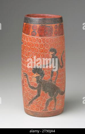 Vase, c. 450-700 CE, 9 11/16 x 4 3/8 in. (24.6 x 11.11 cm), Clay, pigments, Mexico or Guatemala, 5th-7th century, Playful and mischevious black howler monkeys encircle this vase, with juveniles taunting their mothers who hold cacao (chocolate) pods. Rodents, birds, and monkeys in the Maya area of Mesoamerica play a critical role in the propagation of cacao, breaking open the pods to suck out the sweet gooey pulp and then casting away the bitter seeds. The circle with three dots motif in the background may represent cacao seeds. For human consumption, cacao seeds are fermented, dried, roasted Stock Photo