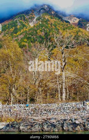 Scenery of Myojin bridge and Azusa river in late autumn at Kamikochi National Park, Matsumoto, Nagano, Japan Stock Photo