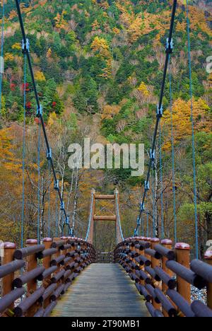 Scenery of Myojin bridge and Azusa river in late autumn at Kamikochi National Park, Matsumoto, Nagano, Japan Stock Photo