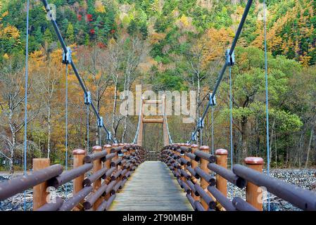 Scenery of Myojin bridge and Azusa river in late autumn at Kamikochi National Park, Matsumoto, Nagano, Japan Stock Photo