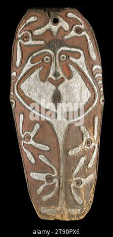 Gope board, 18th century, Unknown, 49 1/2 x 22 in. (125.73 x 55.88 cm), Wood, pigment, Papua New Guinea, 18th century, Gope boards and shields are protective objects that are named after ancestors important to their owners. Ancestors become connected with the objects and help protect the owner from physical or supernatural harm. The gope board, or special shield, shown here was kept in the men’s house in communities in the Papuan gulf region of New Guinea. It belonged to an individual man whose ancestor is depicted on the board, and who was called upon for protection during battle Stock Photo