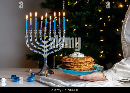 Latkes are traditional Jewish food dish served during Hanukkah. Stock Photo