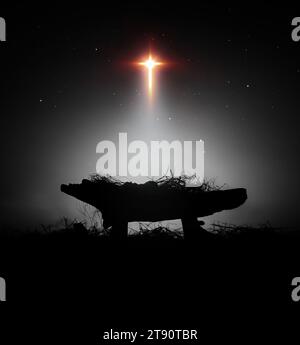 A bright and large star shines brightly, blessing baby Jesus in the manger, celebrating Christmas and alluding to Jesus' birth and death on the cross. Stock Photo