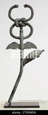 Caduceus, 2nd century, 26 1/8 x 12 3/4 x 5 3/4 in. (66.36 x 32.39 x 14.61 cm) (approx.), Bronze, Roman, 2nd century, A winged rod with two snakes twined around it is an ancient emblem of messengers. Originating in Middle Eastern cultures such as Babylonia (in present-day Iraq), it became an attribute of Hermes, the Greek god of commerce and communication, and of Hermes’ Roman counterpart, Mercury. In Roman myth, Mercury threw his staff at two snakes fighting on the ground, which then ceased fighting and became affixed to the staff Stock Photo