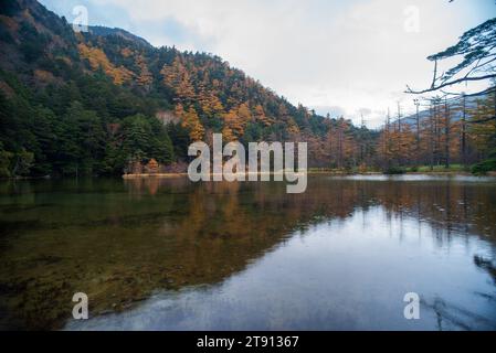 Idyllic landscape of Myojin pond at Hotaka Rear shrine in Kamikochi, Nagano, Japan (Japanese language meaning 'Myojin Pond') Stock Photo