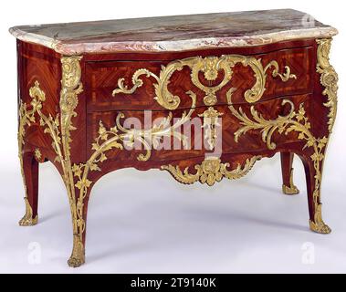 Commode, c. 1745, attributed to Charles Cressent, French, 1685–1768, 35 3/4 x 57 x 26 1/4 in. (90.81 x 144.78 x 66.68 cm), Satinwood and purpleheart, gilt bronze mounts and marble top, France, 18th century, French furniture of the highest quality during the 1700s was adorned with gilt-bronze, called ormolu, mounts. Charles Cressent (1685–1768), a leading French cabinetmaker, was especially noted for his elaborate Rococo gilt-bronze mounts. He trained as a sculptor before turning to cabinetry, and his mounts display a strong three-dimensional organic quality. Stock Photo