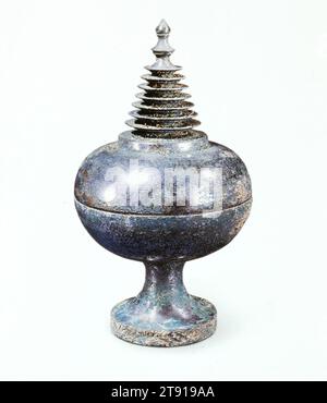 Buddhist Reliquary, 7th-8th century, 7 7/8 x 4 1/2 in. (20 x 11.43 cm), Bronze, China, 7th-8th century, Stupa-form reliquaries were used during the Tang dynasty by priests performing ceremonial worship. Ancient paintings show vessels like this placed on altars in front of Buddha images. Such containers usually held relics of a Buddhist saint (Sarira), or small precious objects that represented these persons Stock Photo