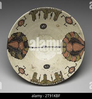 Large bowl with Kufic and Palmette motifs, 10th century, 5 3/16 x 12 7/8 x 12 7/8 in. (13.18 x 32.7 x 32.7 cm), Earthenware with a white slip ground under a clear glaze with red, dark brown, olive and gold slip-painted decor, Iran or Uzbekistan, Samanid dynasty (819-999 CE), Notable for its size, this steep bowl features inner walls with leaf-shaped palmettes united by a narrow, highly abstract mock-Kufic inscription. Two bands of Kufic script in gold appear opposite each other on the rim. Small brown and reddish-brown roundels are positioned between the palmettes and the gold inscriptions Stock Photo