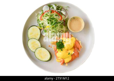 white plate with eggs bennedict waffles with smoked salmon on a white background Stock Photo