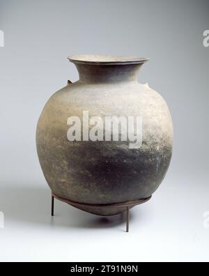 (Storage Jar), 5th century, Unknown Korean, 21 7/8 x 18 3/4 in. (55.56 x 47.63 cm), Stoneware with natural ash deposits, Korea, 5th century, The small, independent kingdom of Kaya on Korea's southern coast enjoyed a rich material culture before it was absorbed by Silla, its powerful neighbor to the east, in 562. Bulbous jars with smooth, unadorned surfaces were created in great numbers by Kaya potters, who may also have influenced the production of a similar ware in Japan's Yayoi period (300 b.c. - a.d. 300). This astoundingly large example also has a small amount of natural ash glaze Stock Photo