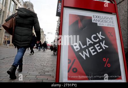 Rostock, Germany. 21st Nov, 2023. A woman walks past a store on the boulevard, a sign reading 'Black Week' advertises special offers. The Northern German Retail Association plans to hold a virtual Christmas press conference on 22.11.2023 to provide information about the upcoming Christmas business in the retail sector. Christmas sales are the strongest period in terms of turnover in many retail sectors. Credit: Bernd Wüstneck/dpa/Alamy Live News Stock Photo