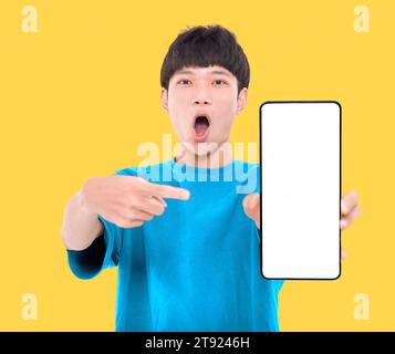 Happy Asian teenaher student holding smartphone mockup of blank screen Stock Photo