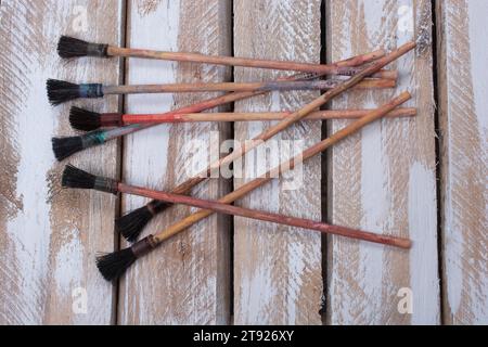Paint brushes on technique ebru art on wooden background Stock Photo