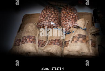 Ripe unshelled hazelnuts as nut background in package bags Stock Photo