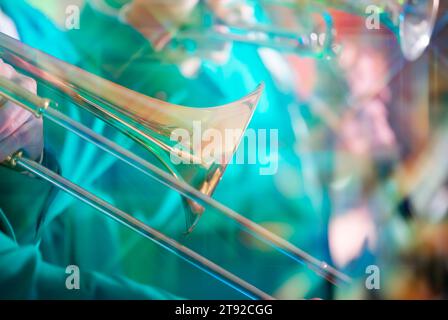 Blurred musical background with golden trumpets on an emerald background. Musical poster. Stock Photo