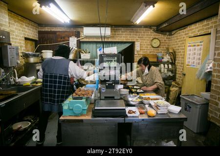 Ogi, Japan 1st October 2023: Japanese grocery store with two women preparing bento boxes. Stock Photo